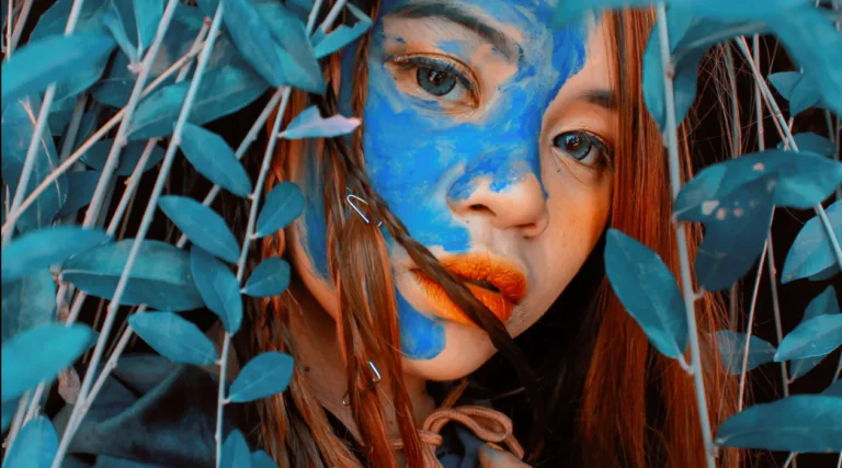 A woman with blue makeup on her face.