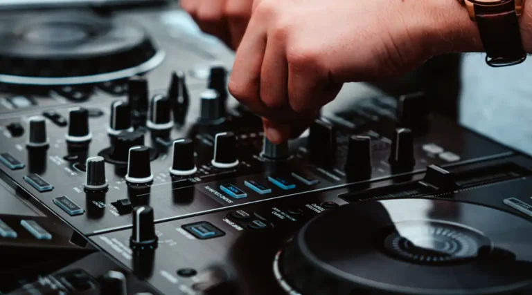 A person is using the knobs on a dj controller.