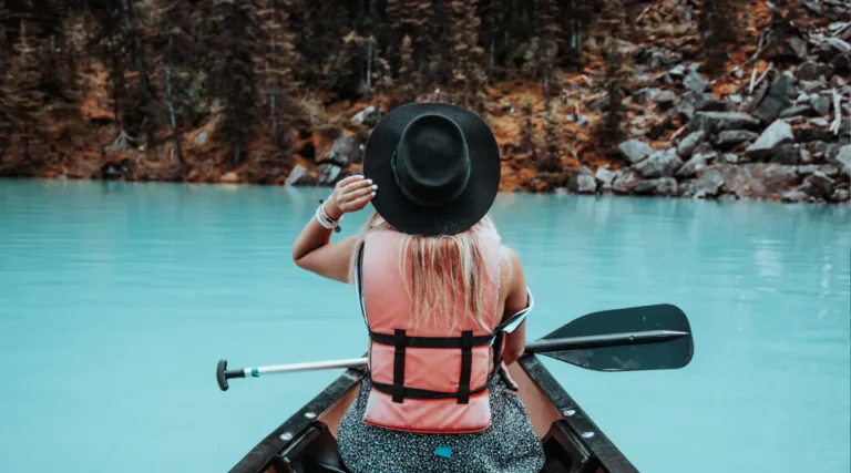 A woman in a canoe on the water.