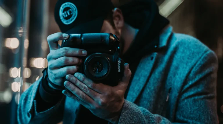 A man holding a camera in his hands.