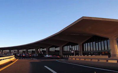 A long line of cars parked at an airport.