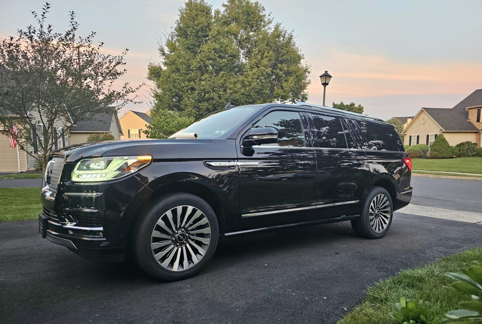 A black suv parked on the side of a road.