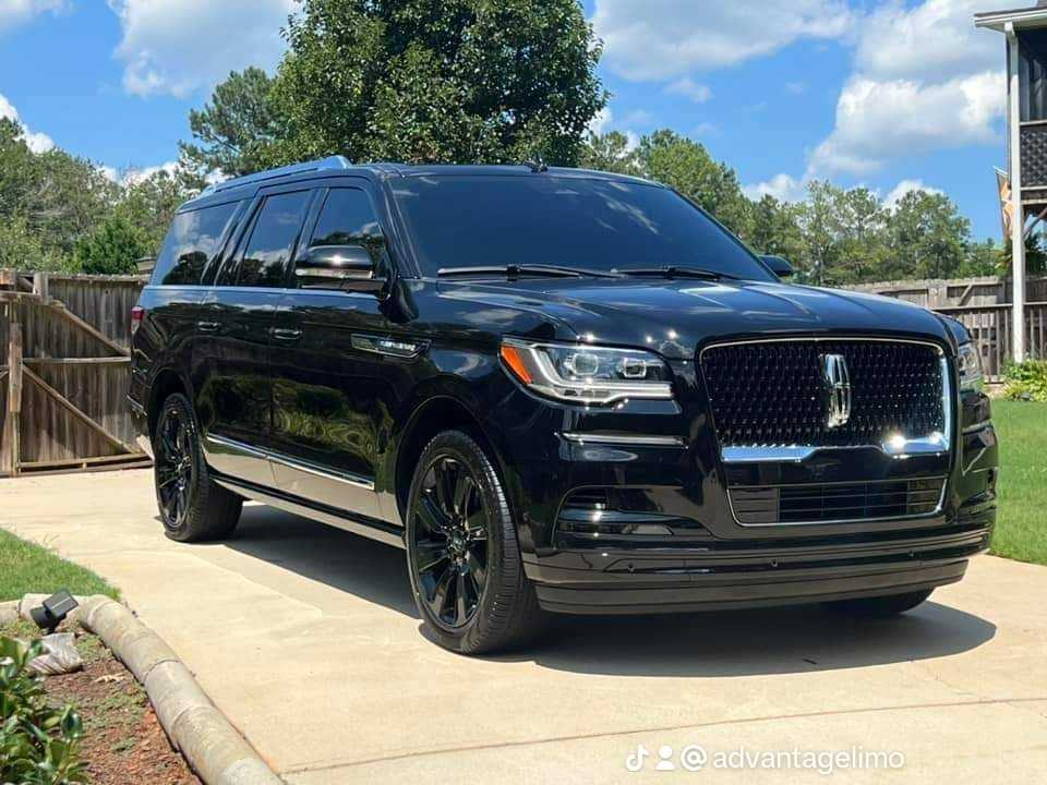 A black suv parked on the side of a road.