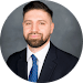 A man in suit and tie with beard.