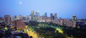 A city skyline with lights at night.