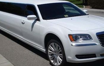 A white limo is parked on the street.