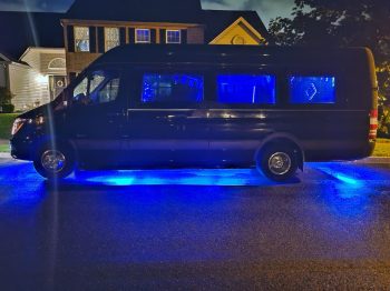 A van parked in the middle of a driveway.