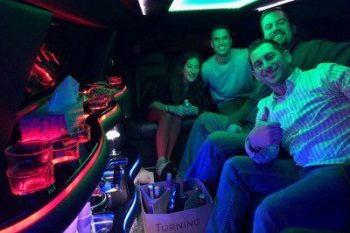 A group of people sitting in the back of a limo.